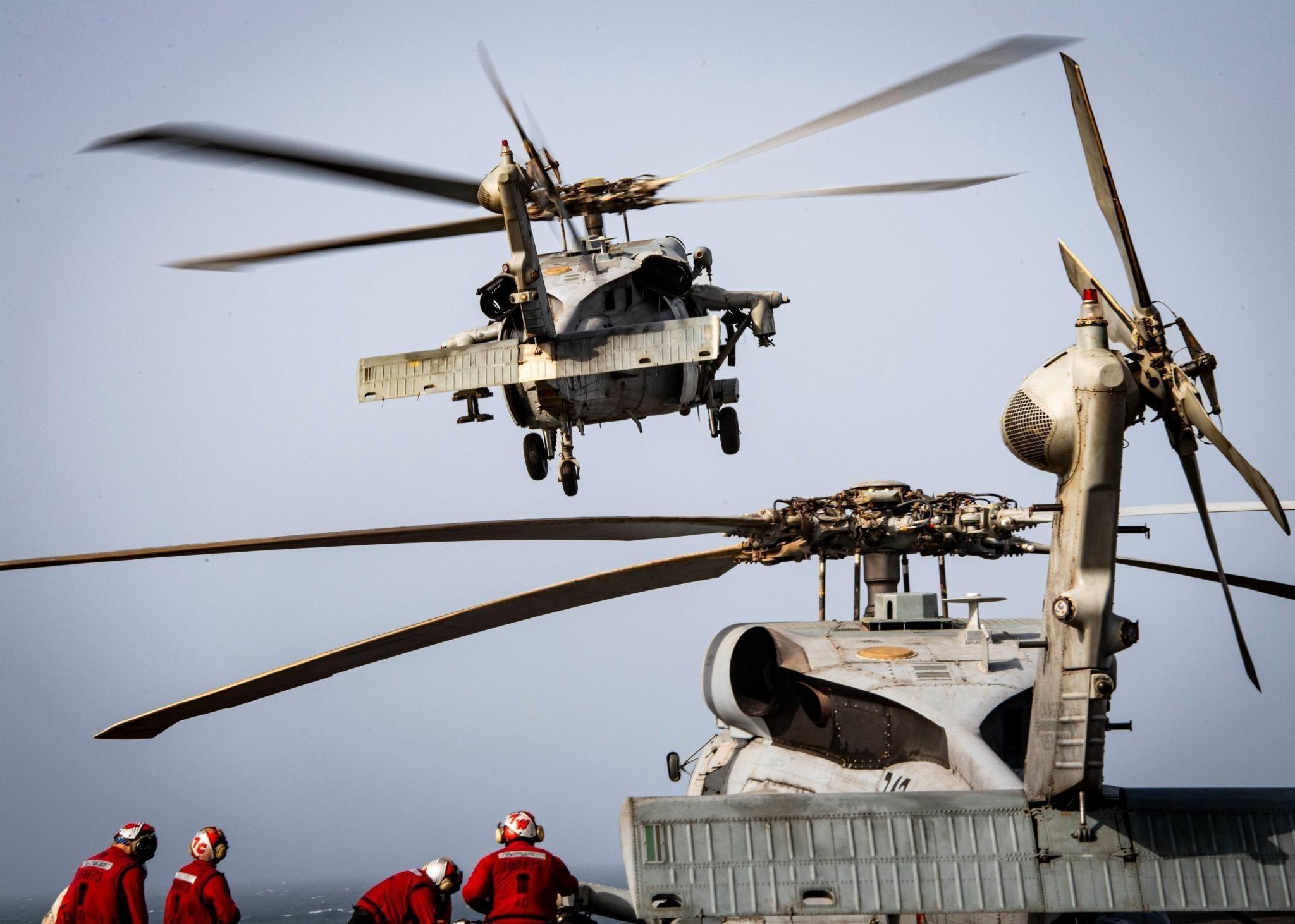 MH-60S Sea Hawk helicopters take off from the flight deck of the Nimitz-class aircraft carrier USS Nimitz (CVN 68) during flight operations in the U.S. Central Command area of responsibility. (CENTCOM)